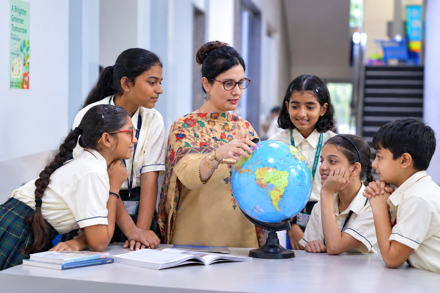 A teacher showing students a globe
